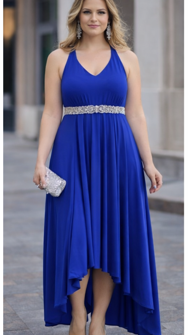 Woman wearing a blue dress with a high-low hemline in an urban setting.