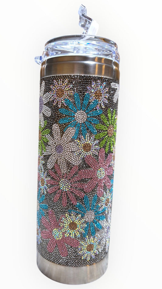 A stainless steel insulated drink container with a floral pattern and multicolored floral designs.