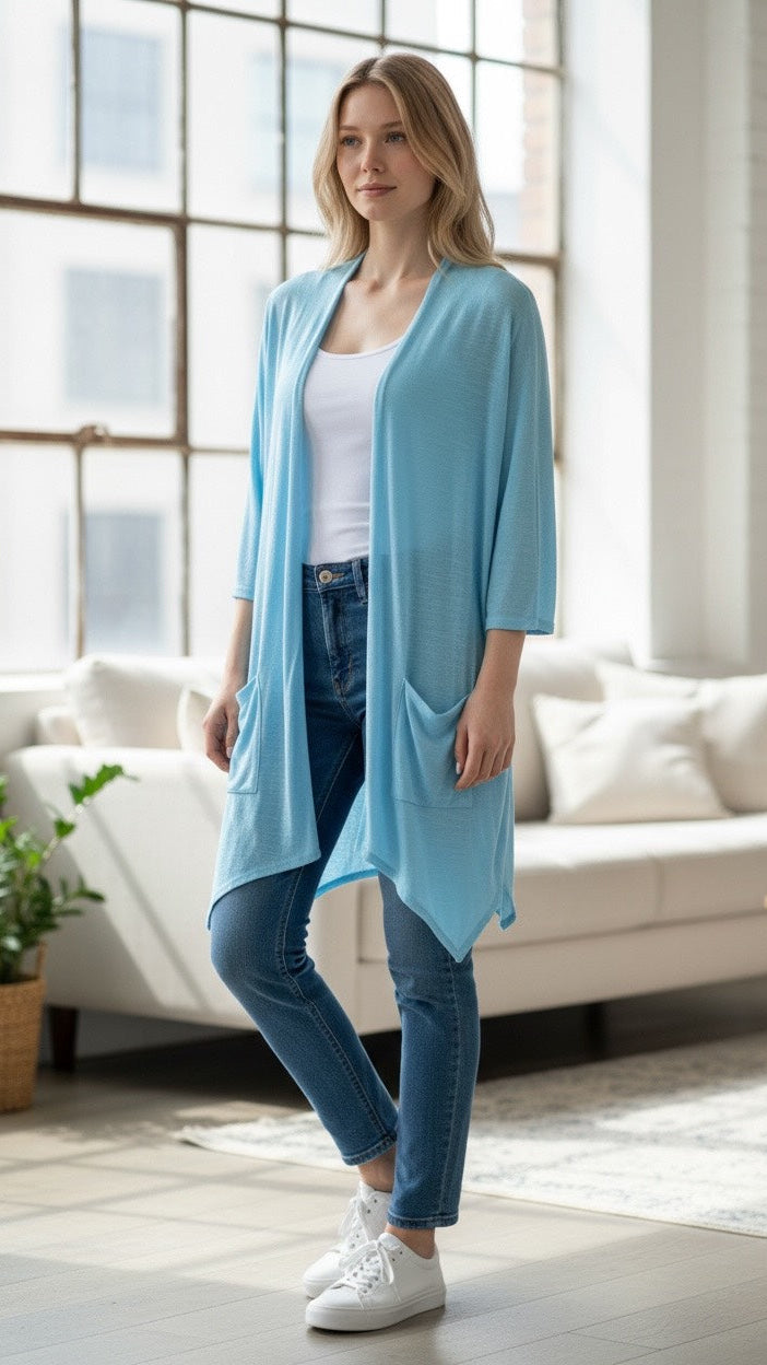 Women’s linen cardigan with lightweight, breathable fabric, relaxed fit, and functional side pockets, available in blue or white