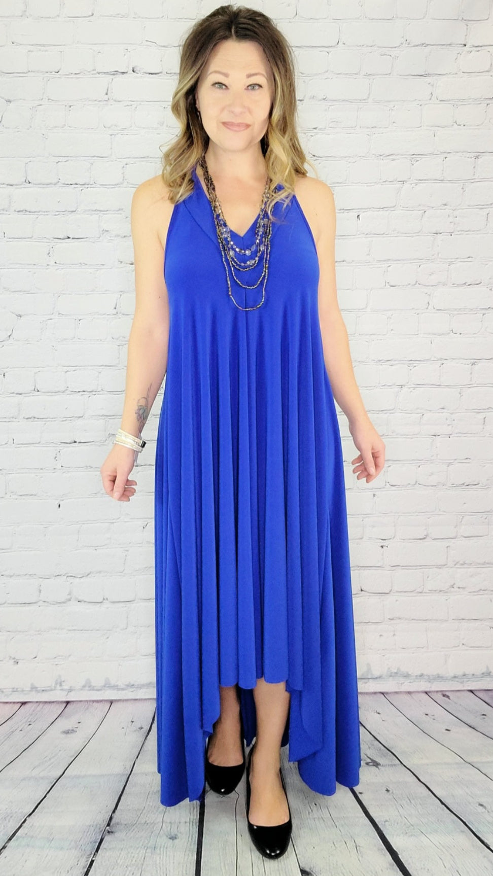 Royal blue high-low dress with adjustable back straps, soft stretchy fabric, and flowing hemline, versatile for weddings, resort wear, or special occasions